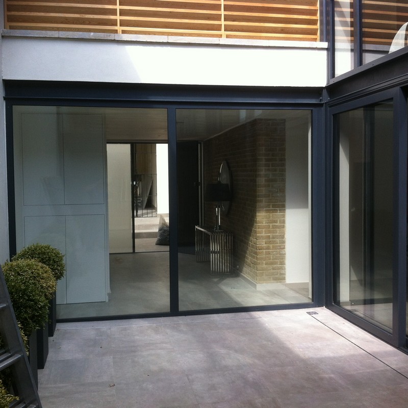 Floor-to-ceiling sliding doors opening to courtyard in Morden