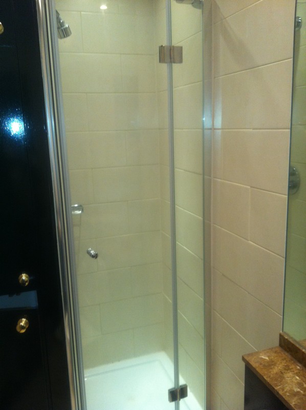 Frameless glass shower enclosure with chrome fittings in Morden