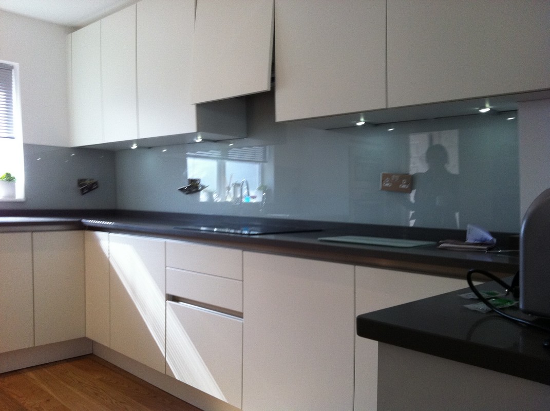 Grey glass kitchen splashback with LED lighting in Morden